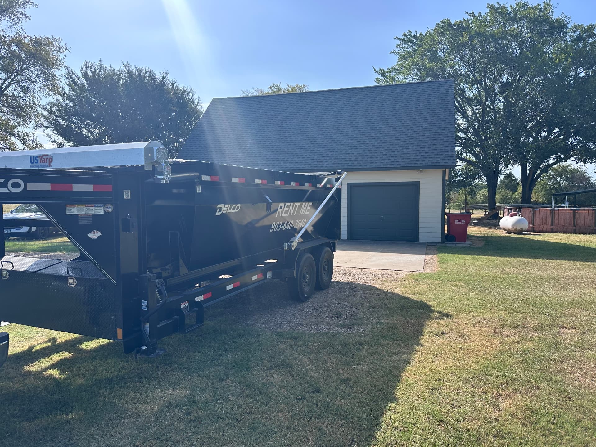 HomeHaven 16-yard roll-off dumpster placed on a driveway for a garage cleanout in Bonham, Fannin County, Texas