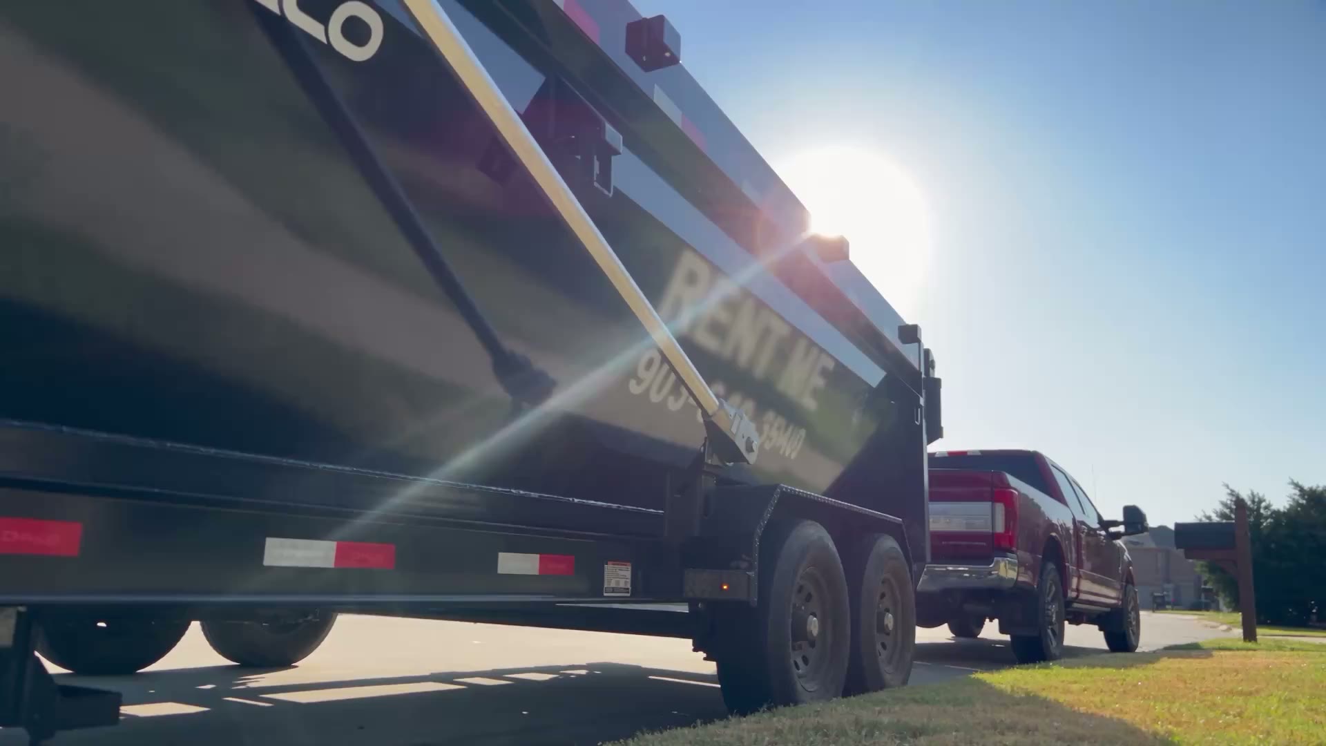 A HomeHaven roll-off truck arriving on a North Texas street to place a 16-yard dumpster